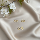 Trio de Brincos Dourados – Estrela, Mão Hamsá e Pézinho